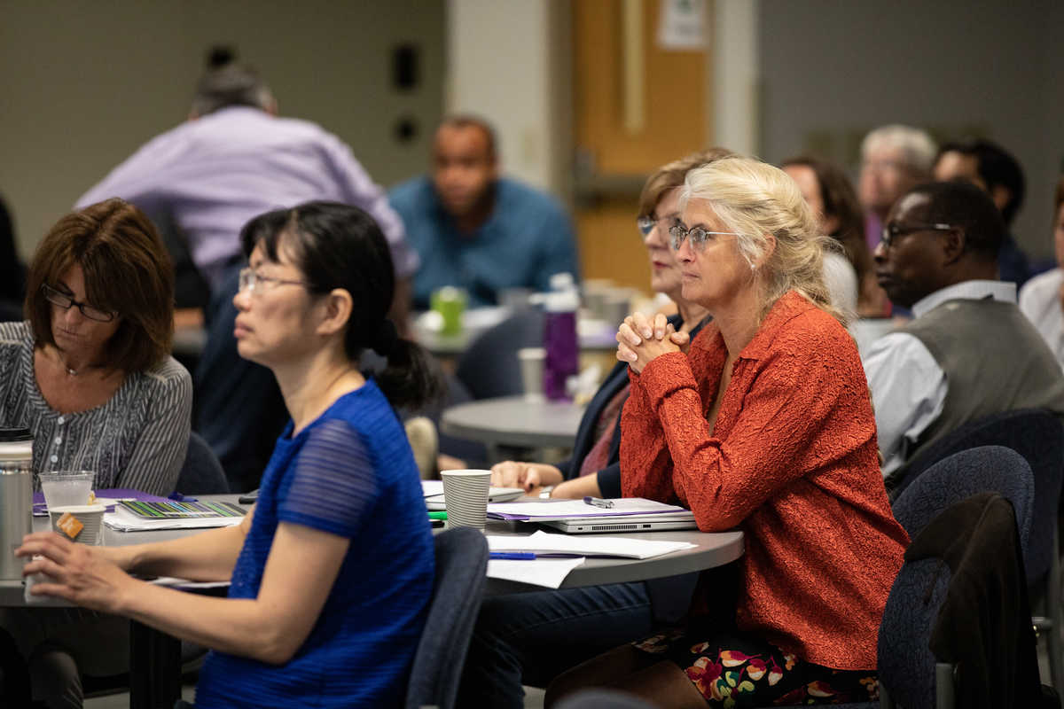 Teachers listening to lecture on trauma informed education