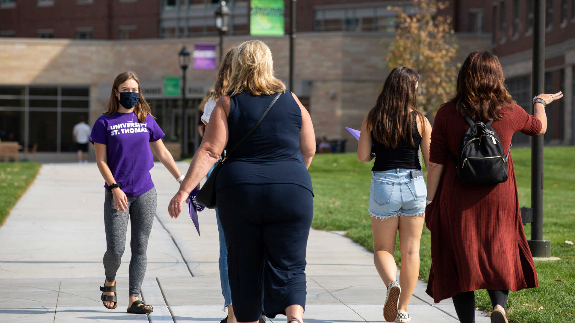 Tour guide showing guests around campus